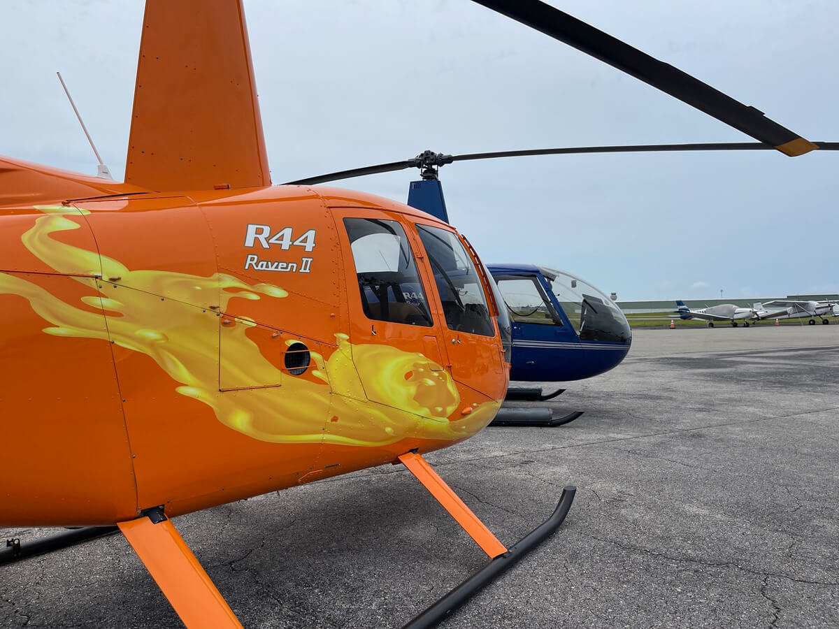 R44 raven helicopters standing
