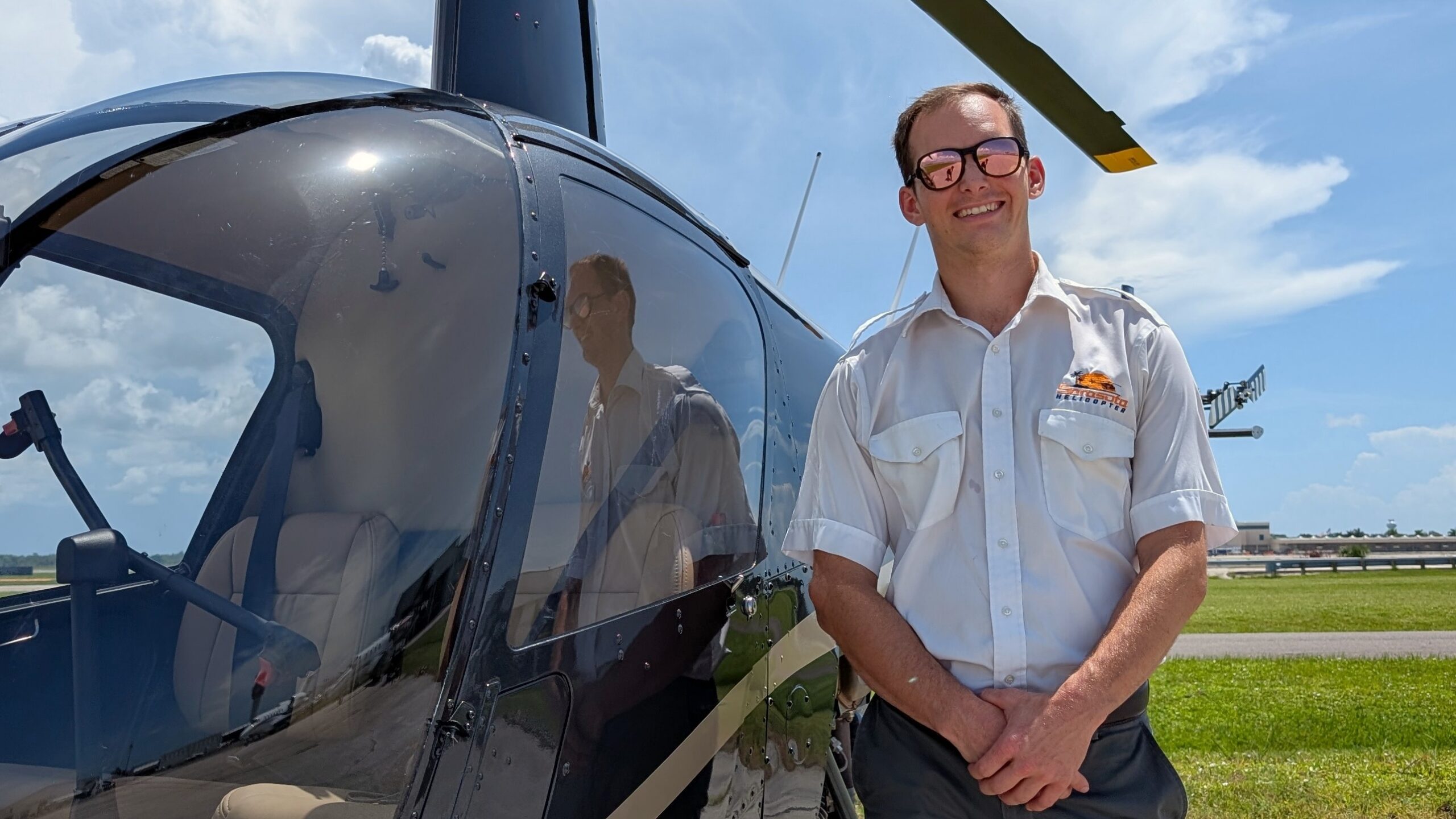 Pilot standing next to helicopter