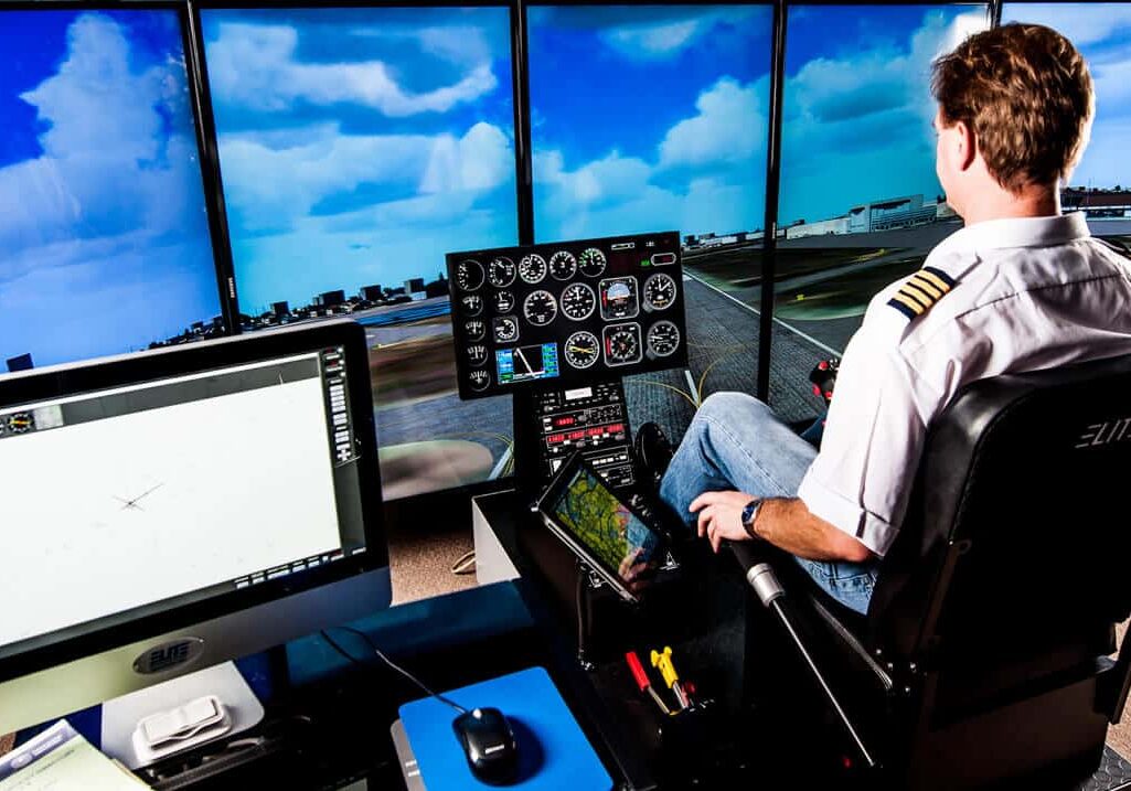 man-playing-simulator Man Practice Elite Helicopter Simulator